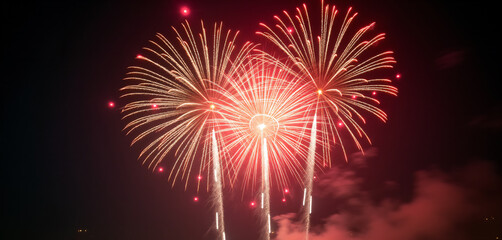 Brilliant Fireworks: Red Bursts and Sparks in Night Sky