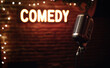 © Curioso.Photography - Microphone on stage with a neon comedy sign in the background.