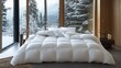 © Lexyat - White down comforter on a bed in a modern bedroom with large windows overlooking a snowy forest.