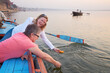 © Rowena Naylor/Stocksy - Tourists experience placing Diyas in Ganges River