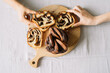 © Adrian Cotiga/Stocksy - Variations of chocolate swirl bread on wooden board.