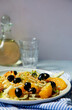© Helen Rushbrook/Stocksy - Natural light image of a fennel, black olive and orange salad.