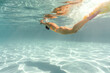 © Andriy Bezuglov/Stocksy - Woman swims underwater during her training in pool