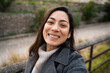 © Alberto Midnight/Stocksy - A happy hispanic business woman taking a selfie after work