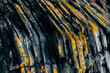 © VICTOR TORRES/Stocksy - Close-up of rugged rock surface with unique yellow and black patterns