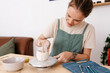 © Tania Cervian/Stocksy - Focused potter crafting ceramic vase on wheel