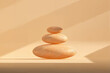 © Marcos Osorio/Stocksy - Balanced zen stones in soft light against a minimalist background
