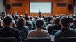 © Arpatsara - A diverse audience attentively listens to a speaker at a professional conference, fostering engagement and learning opportunities.