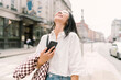 © Mattia/Stocksy - Woman Checking Phone in City