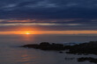 © VICTOR TORRES/Stocksy - Coastal sunset over rocky shore with dramatic clouds
