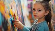 © Hungarian - Young girl in blue sweater painting on a canvas with a brush