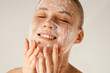 © Asya Molochkova/Stocksy - Washing face with soap beauty product