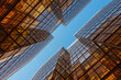 © Heng Yu/Stocksy - Symmetrical Glass Buildings Reflecting Golden Light Against Blue Sky