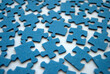 © Tassya - Blue jigsaw puzzle pieces close-up. Blue puzzles on white.  Jigsaw puzzle background. Challenge and solution concept. Teamwork.