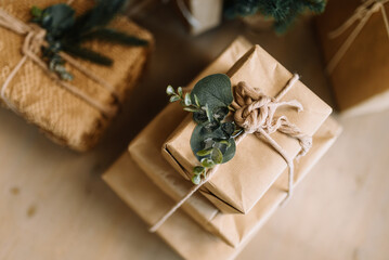 Gift boxes in a natural style: minimalist packaging made of kraft paper and decorative details from natural materials