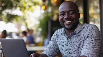 Sticker - Smiling Man Working on Laptop in Outdoor Café Setting