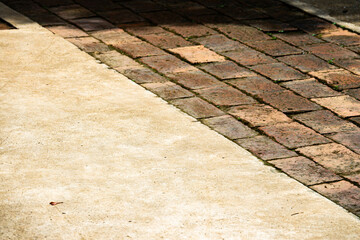 Wall Mural - A brick walkway with a white border. The white border is made of concrete and the bricks are brown