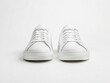 © ekampos - A mockup of white sneakers, front view, isolated