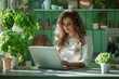 © Benjamin - Woman working from home using laptop in kitchen with plants