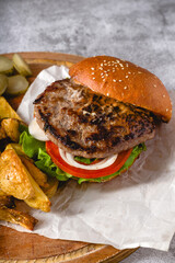 burger with Tomatoes and Pickles with French Fries and Ketchup