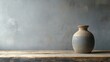 © MakoPoko - Simple vase resting on a rustic wooden table against a plain gray wall minimalist interior decor concept