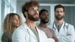 © Larisa AI - Four diverse medical professionals, two in coats, stand confidently together, showcasing teamwork, expertise, and dedication in a healthcare setting.