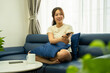 © STOCK88PHOTOGRAPHER - Image of young Asian girl watching TV and relaxing at home