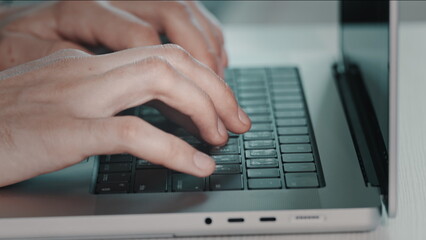 Man hands typing on laptop close up. Online project, report research at desk. Planning, business, freelancer student using laptop studying online working from home in internet. Blue toning side view