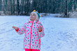 © Irina Schmidt - Funny Little Girl Having Fun in Beautiful Winter Park. Happy school child playing with snow, happiness about snowfall and winter activities.