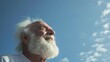 © VK Studio - A content elder looks into the blue sky, his expression embodying peace, joy, and the freedom of open spaces.