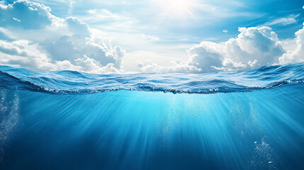 Wall Mural - blue sea or ocean water surface and underwater with sunny and cloudy sky: a split view featuring the