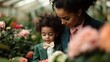 © Maximages  - A mother and child in matching green suits with bow ties admire beautiful pink flowers in a vibrant setting, symbolizing togetherness and appreciation.