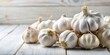 © beng - Forced perspective composition of fresh garlic on white wood