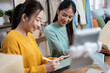 © Jirakul - Young Entrepreneurs Live Streaming and Packing Orders for Online Fashion Store in Living Room