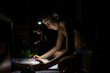 © misu - Blackout in Ukraine. Teenager playing pinball with a headlamp