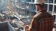 © Attasit - Engineer portrait with a tablet, looking at a building under construction