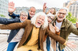 © Davide Angelini - Happy group of senior people smiling at camera together outside