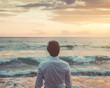 © Qstock - Contemplative Man Looking Out at the Ocean Sunset - Reflective Moment by the Sea Photograph