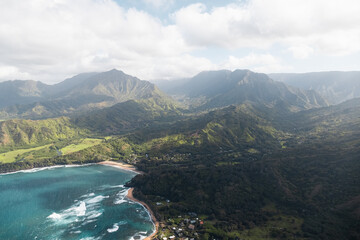 View of Kalalau Trailhead, Haena State Park and Tunnels Beach at the Na Pali Coast on Kauai during a helicopter tour (Hawaii, USA)