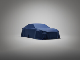 A car veiled in a blue fabric on a seamless gray background. Studio or trade show setting.