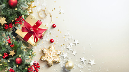 Wall Mural - christmas light background with beautiful golden gift decorated with fir branches, top view.
