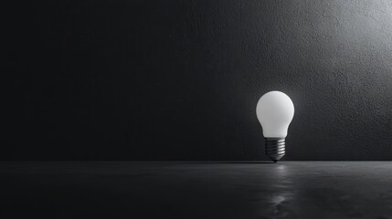 A glowing light bulb illuminated against a dark background, symbolizing ideas and innovation.