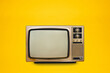 © Pituk - Vintage, retro old TV (television) with blank screen isolated on yellow background, front view, clipping path