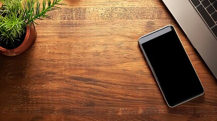 Workplace scene with a laptop and mobile phone on a wood desk, designed as a banner with copy space..