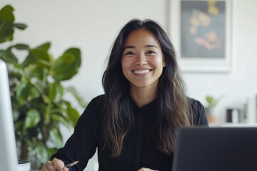 Canvas Print - A woman sitting in front of a laptop computer, focused on her work or study