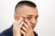 © ALEXEY - Man 35-40 years old with eye injury after fight, portrait on white background.