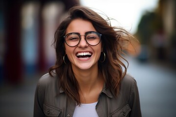 Poster - Portrait of a beautiful young woman laughing and looking at the camera