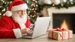 © lililia - In a cozy workshop illuminated by a fireplace, Santa Claus opens gift boxes while using a laptop to write personal holiday messages for children and families.