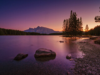Wall Mural - two jack lake, banff national park, alberta, canada. mountain landscape at dawn. sunbeams in a valle