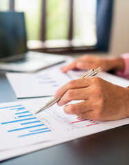 Business accounting concept, Business man using calculator with computer laptop, budget and loan paper in office.
